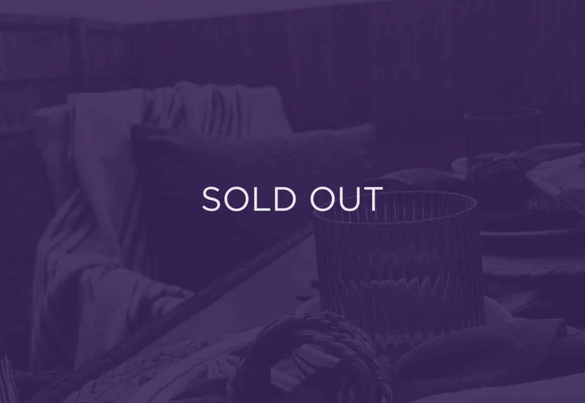An image of a table, with a purple overlay and text that says sold out.