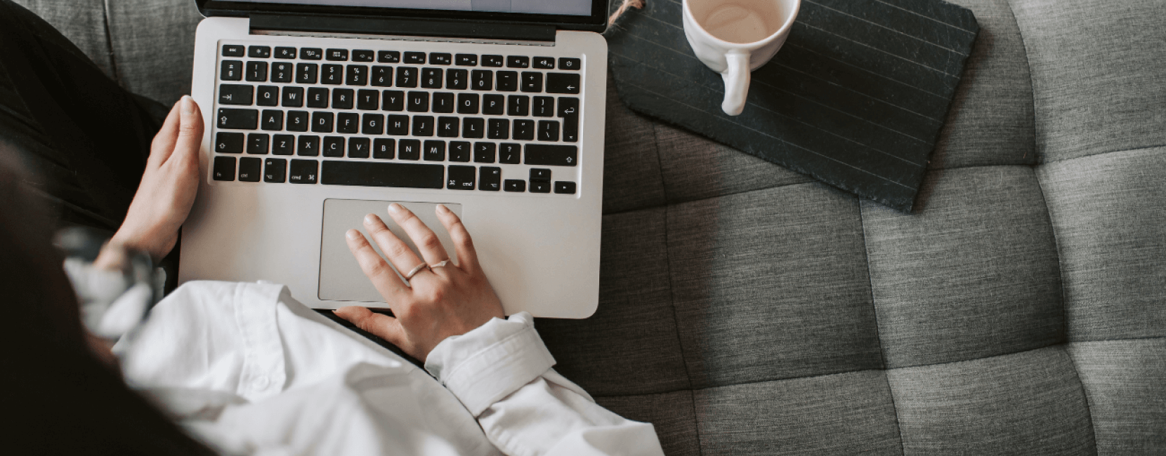 Woman using laptop on sofa