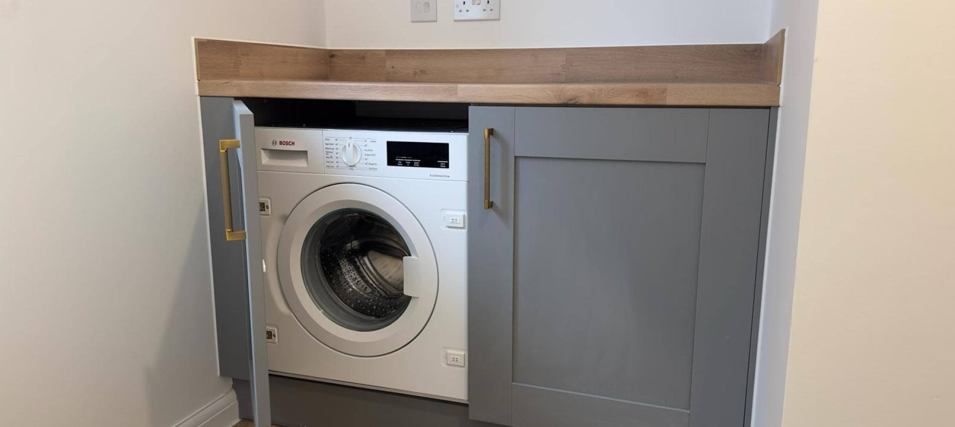 Utility Room with Integrated Washing Machine at The Spruce.