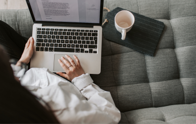 Woman using laptop on sofa