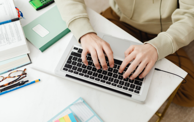 Unidentifiable person typing on laptop 