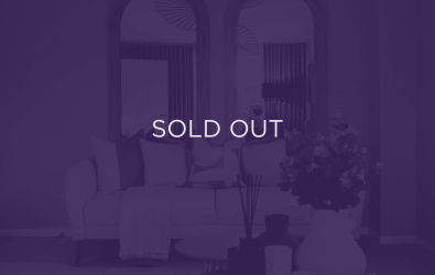 an image of a sofa in front of mirrors, with a purple overlay and text that says sold out