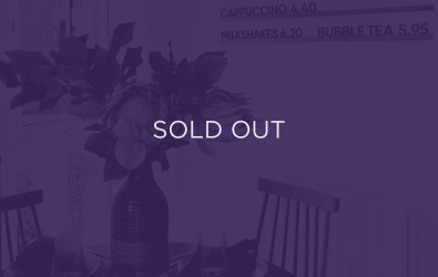 an image of flowers on a dining table, with a purple overlay and text that says sold out