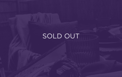 An image of a table, with a purple overlay and text that says sold out.