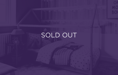 An image of a bed, with a purple overlay and text that says sold out